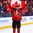 BUFFALO, NEW YORK - JANUARY 5: Canada's captain Dillon Dube #9 skates around the ice with the flag in celebration of his team's championship victory over Sweden in the gold medal game of the 2018 IIHF World Junior Championship. (Photo by Andrea Cardin/HHOF-IIHF Images)

